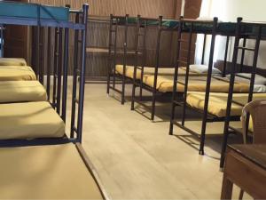 a row of bunk beds in a room at Matha Residency Munnar in Suryanelli +2 photos