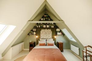 a bedroom with a bed in a attic at Clos des sentiles in Perros-Guirec