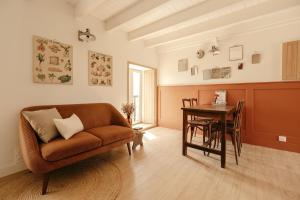 a living room with a couch and a table at Clos des sentiles in Perros-Guirec
