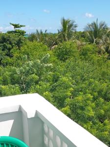 a view of trees from the balcony of a house at Fumbatown's Finest in Mchamba Wima