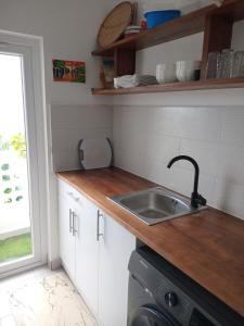a kitchen with a sink and a dishwasher at Fumbatown's Finest in Mchamba Wima