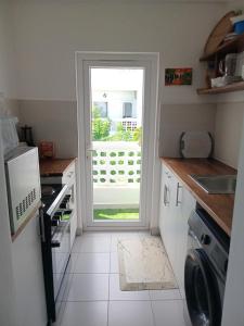 a kitchen with a door leading to a yard at Fumbatown's Finest in Mchamba Wima +2 photos