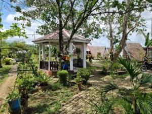 a small house with a gazebo in a village at Maria Francisca Hometead  +12 photos