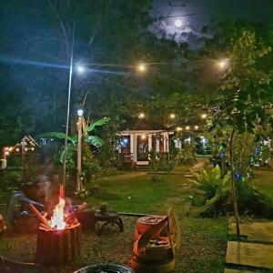 a fire pit in a yard at night at Maria Francisca Hometead 