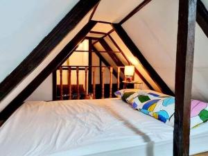 a bedroom with a bed in a attic at Maria Francisca Hometead 