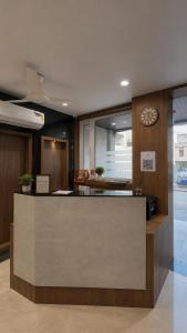 a lobby with a reception desk in a building at Hotel Casa Square in Indore