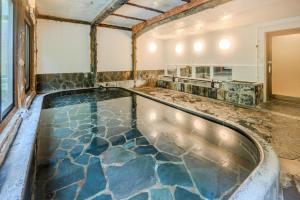 a pool of water in a bathroom with a spa at Ichinoyu Honkan in Hakone