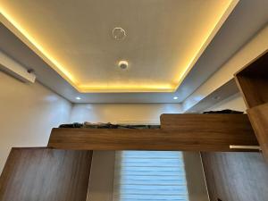 a bedroom with a bunk bed with a window at Cozy Modern Loft Studio in Cubao in Manila
