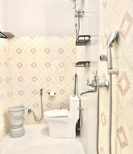 a bathroom with a toilet and a shower at The Mango Tree by ANAND VILLA in Jodhpur +94 photos
