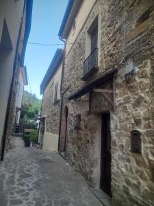 an alley in an old stone building with a balcony at B&B Il borgo incantato in Laureana Cilento
