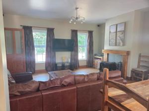 a living room with a couch and a table at Lawnside Retreat in Mullinavat