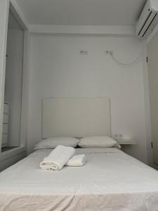a white bed with two towels on top of it at 3-Bedroom Home, Free Parking,10 Minutes from Seville in Camas