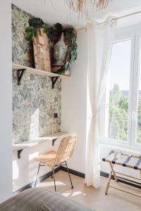 a bedroom with a chair and a window at M a g i c & J u n g l e in Verdun-sur-Meuse +22 photos