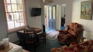 a living room with a couch and a chair and a table at Mews Apartments in Lincoln