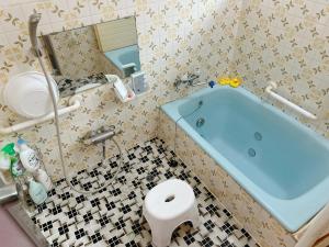 a bathroom with a blue tub and a toilet at JIKKA KYOTO MAIZURU Private - Kominka House for Groups & Families - Vacation STAY 21302 in Kuradani +29 photos