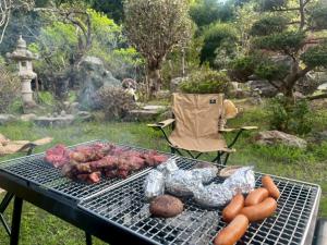 a grill with some meat and vegetables on it at JIKKA KYOTO MAIZURU Private - Kominka House for Groups & Families - Vacation STAY 21302 in Kuradani