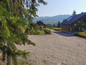 a garden with a pavilion and a playground at Căsuțele MukSot in Vatra Dornei