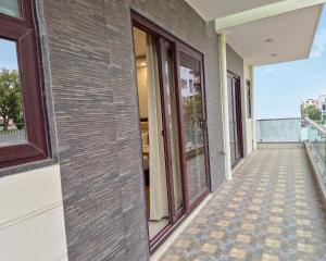a corridor of a building with glass doors at Hotel Retro Folic Near Golf Course Road & Cyber City in Gurgaon