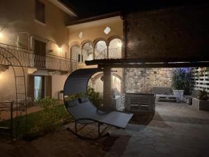 a house with a chair in front of a patio at L'orchidea del Lago in Soiano del Lago