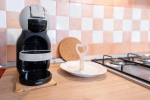 a coffee maker sitting on a counter next to a plate at A Cuor Leggero Home in Viterbo