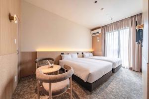 a hotel room with a bed and a table at Apartment Hotel 11 Shinsaibashi 9 in Osaka