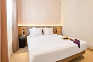 a bedroom with a large white bed in a room at Ocean Drive Málaga - New Opening 2026 in Málaga