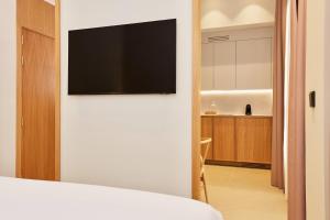 a living room with a flat screen tv on a wall at Ocean Drive Málaga - New Opening 2026 in Málaga +33 photos