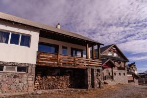 a house with a wooden deck on the side of it at Chabarukhi Gudauri Truso in Gudauri