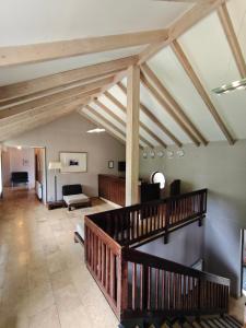 a living room with wooden ceilings and a staircase at Chabarukhi Gudauri Truso in Gudauri