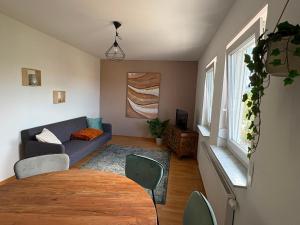 a living room with a table and a couch at WeLiving Apartments in Weinheim