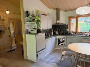 a kitchen with a table and a counter top at Villa Lena in Kouvola