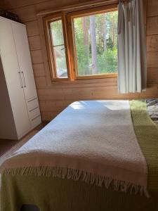 a bedroom with a bed and a window at Villa Lena in Kouvola