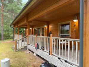a porch of a wooden cabin with a sink at Villa Lena in Kouvola +56 photos