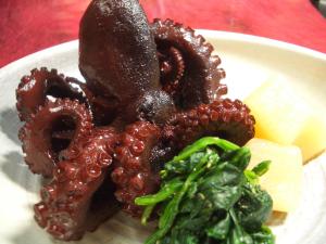 a plate of food with an octopus and vegetables at Uminoyasuragi Hotel Ryugu in Kami Amakusa
