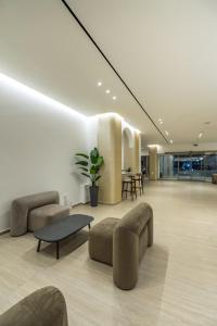 a lobby with couches and a table in a building at Sun Palace Protaras Waterpark Resort in Protaras +130 photos