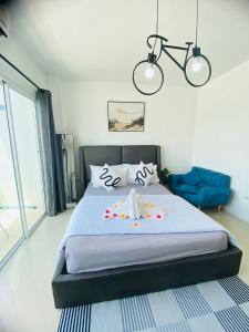 a bedroom with a bed with two towels on it at Exclusive Sea View in Chon Buri