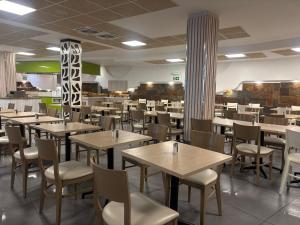 a dining room with tables and chairs in a restaurant at Turbo Club in Maspalomas