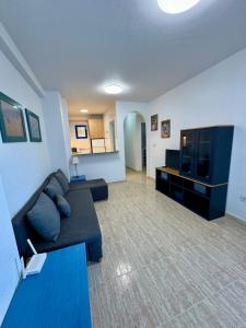 a living room with a couch and a flat screen tv at Aquamarine home in Campoamor +6 photos
