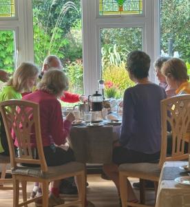 a group of people sitting around a table at Arch House in Florencecourt