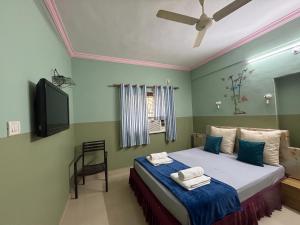 a bedroom with a bed and a flat screen tv at FabHotels Fiora in Pune