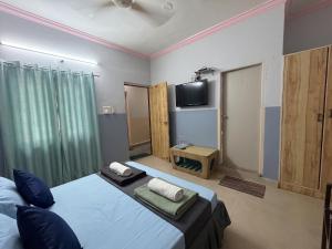 a bedroom with two beds and a flat screen tv at FabHotels Fiora in Pune