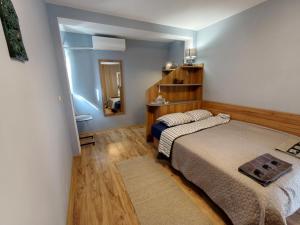 a bedroom with two beds and a mirror at Skalolazka 2 in Belogradchik