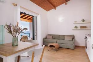 a living room with a couch and a table at Coastal Bliss Apartments in Glyfada