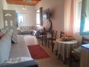 a living room with a couch and a table at Anemomylos House in Kámpos