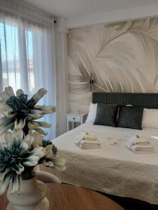 a bedroom with a bed with a vase of flowers at Beltà di Spello in Spello