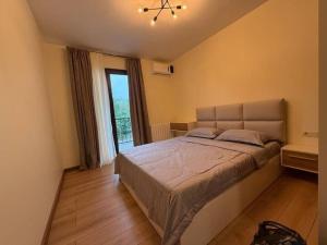 a bedroom with a large bed and a window at Black sea batumi in Chakvi