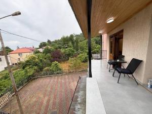 a balcony of a house with a table and chairs at Black sea batumi in Chakvi