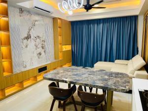a living room with a table with chairs and a couch at Sentral Suites By Eassy Hotel in Kuala Lumpur