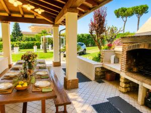 a wooden table on a patio with a fireplace at La Dolce Vita - Private Villa with Pool in Moniga