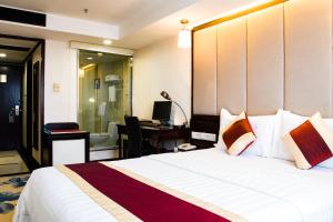 Letto o letti in una camera di New World Hotel